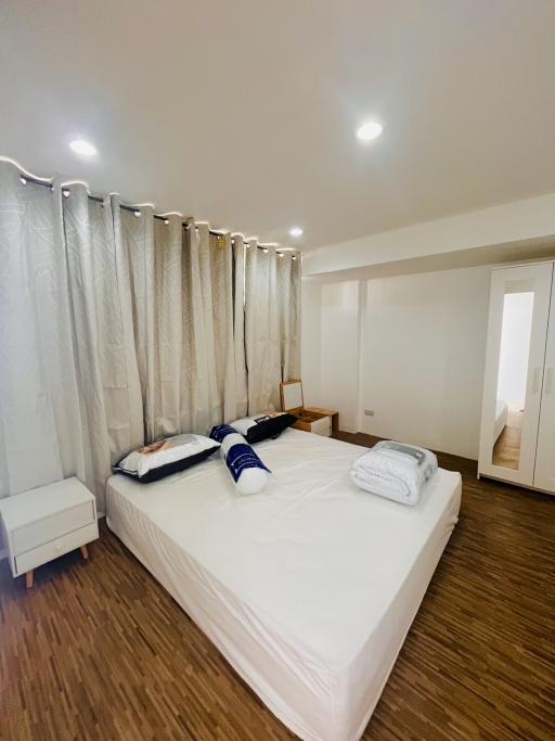 Spacious modern bedroom with wooden flooring