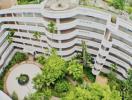 Aerial view of a residential building's courtyard with lush greenery