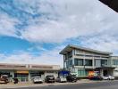 Exterior view of a commercial building with parking and a clear sky