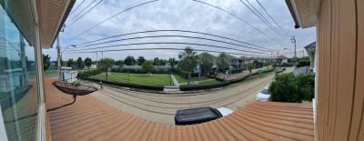 Spacious balcony with a panoramic suburban view featuring a hammock and basketball hoop