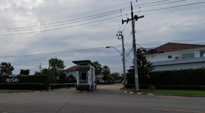 Exterior view of residential area with security booth and gate