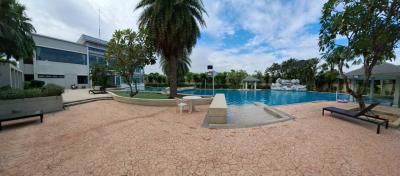 Spacious outdoor swimming pool with lounging chairs and landscaped surroundings