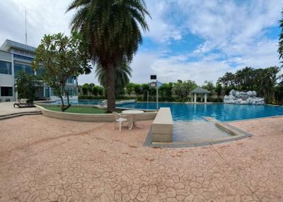 Spacious outdoor swimming pool with lounging chairs and landscaped surroundings