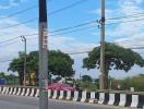 Street view with direction signpost and utility poles