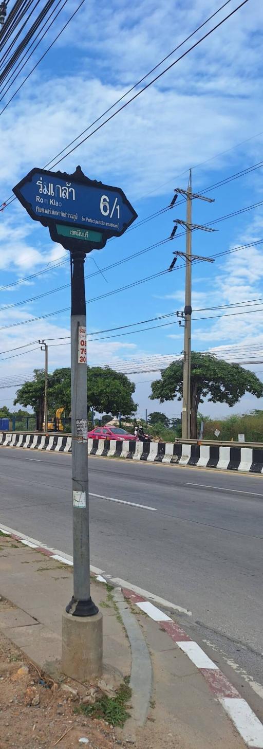 Street view with direction signpost and utility poles