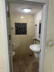 Compact bathroom with tiled walls and modern fixtures