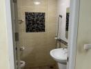 Compact bathroom with tiled walls and modern fixtures