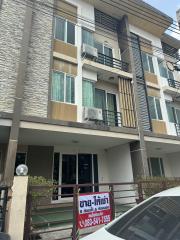 Multi-story residential building with balcony and exterior air conditioning unit