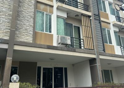 Multi-story residential building with balcony and exterior air conditioning unit