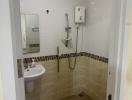Compact bathroom with white fixtures and wall-mounted shower
