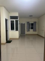 Empty interior of a residential space with tiled flooring