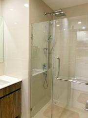 Modern bathroom with glass shower enclosure and tiled walls