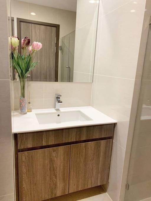 Modern bathroom with sleek fixtures and wooden vanity