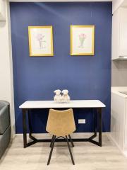 Modern dining space with blue accent wall and framed artwork