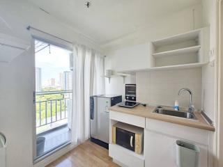 Compact kitchen with modern appliances and balcony access