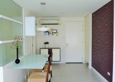 Modern compact kitchen with dining area in a bright apartment