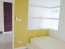 Bright bedroom with a single bed and yellow walls