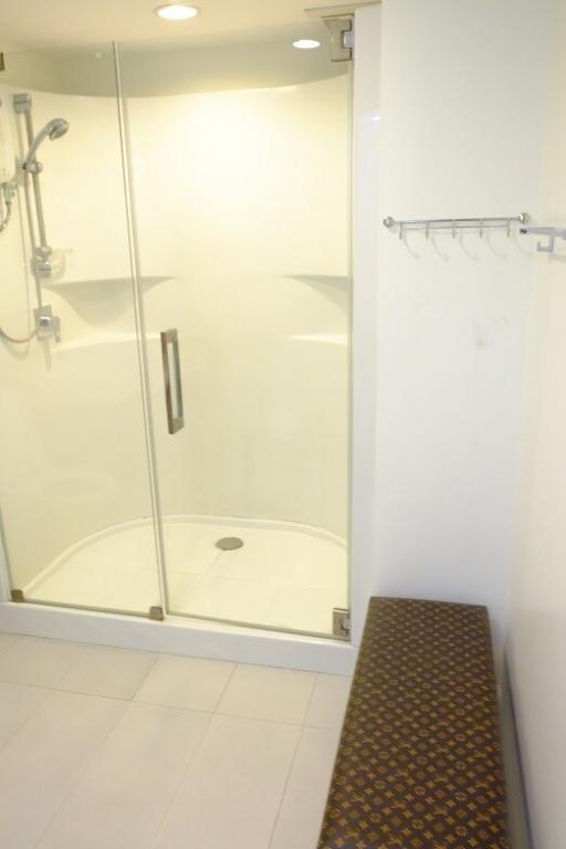 Modern bathroom with glass shower enclosure and bench seating