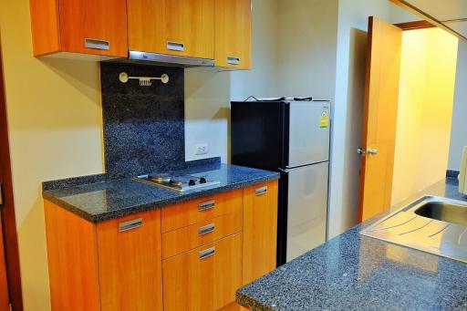 Modern kitchen interior with wooden cabinets and granite countertops