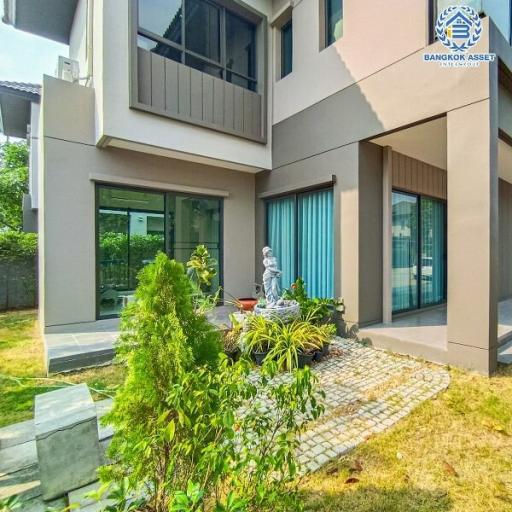 Modern two-story house with garden and statue