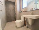 Modern bathroom with wall-mounted fixtures and grey tiling