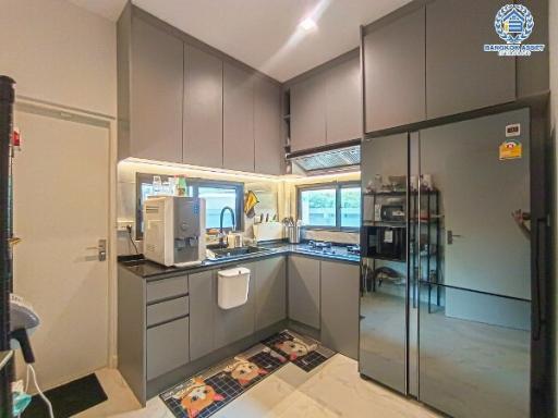 Modern kitchen with grey cabinets and black countertops