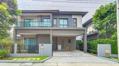 Modern two-story house with a spacious driveway and balcony