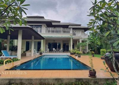 Luxurious two-story house with swimming pool and lush garden