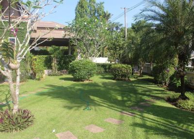 Spacious garden with lush greenery and pathways