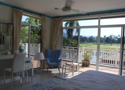 Spacious bedroom with a view of the golf course and abundant natural light