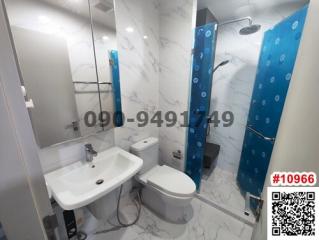Modern bathroom with blue shower partition and marble-style tiles