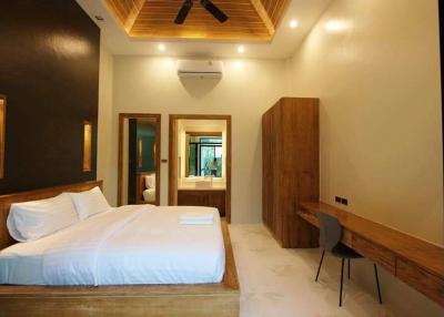 Elegant modern bedroom with wooden accents and en suite bathroom
