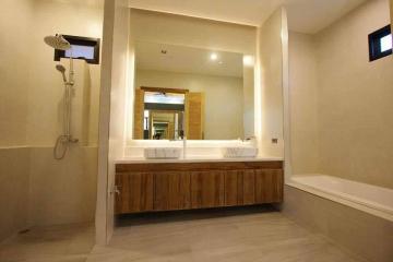 Modern bathroom with dual sinks and large mirror