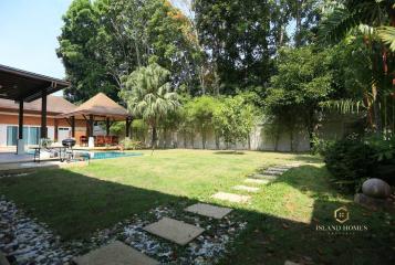 Spacious backyard with pool and lush greenery