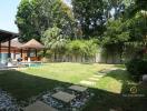 Spacious backyard with pool and lush greenery