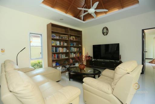 Spacious living room with modern furniture and wooden ceiling