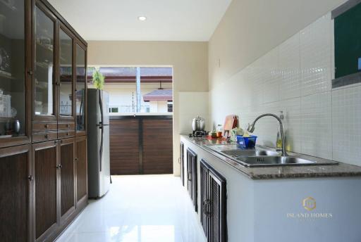 Modern kitchen with stainless steel appliances and wooden cabinetry