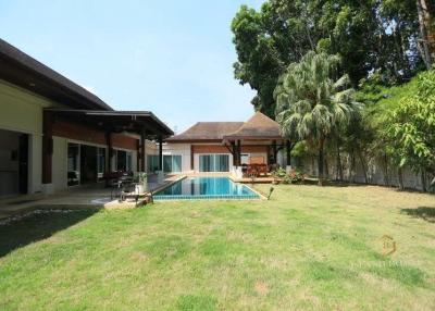Spacious backyard with swimming pool and lawn