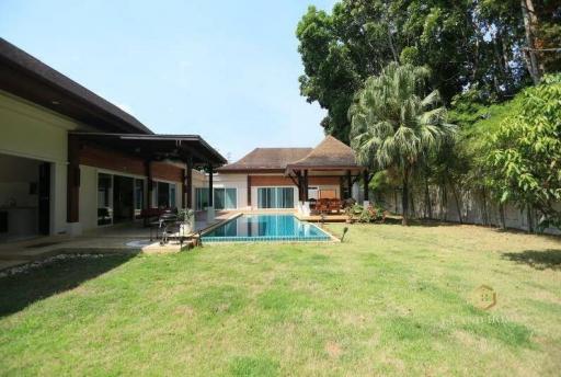 Spacious backyard with swimming pool and lawn