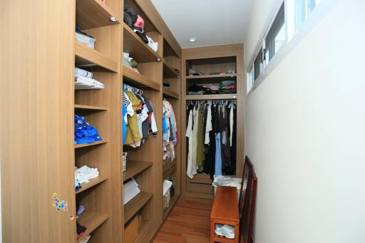 Spacious walk-in closet with built-in shelves and clothing racks