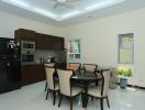 Modern kitchen with dining area, fully equipped with stainless steel appliances