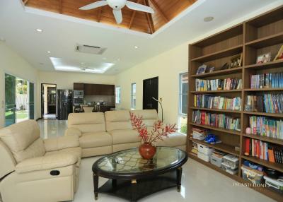 Spacious living room with bookshelf and modern appliances