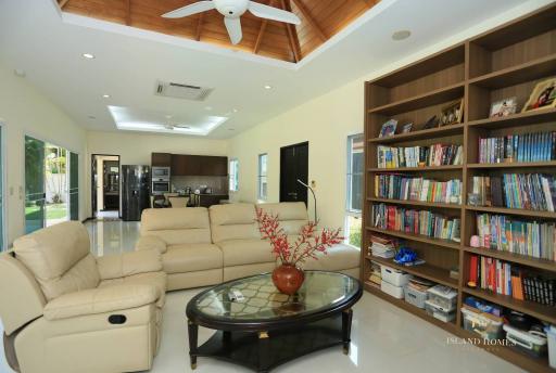 Spacious living room with bookshelf and modern appliances