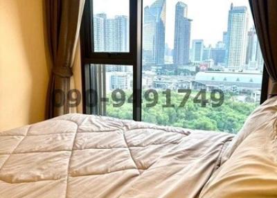 Cozy bedroom with a city view through a large window