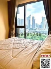 Cozy bedroom with a city view through a large window