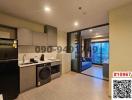 Modern kitchen with attached open living room space featuring contemporary furniture