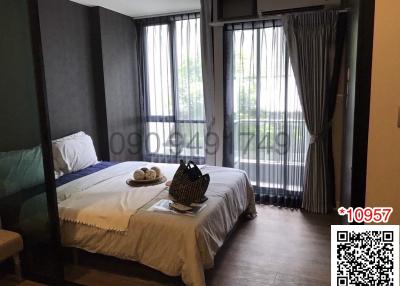 Cozy bedroom with natural light and balcony access