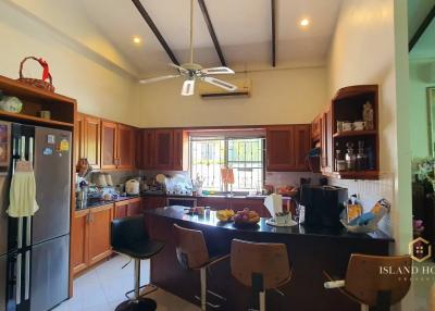 Spacious kitchen with wooden cabinets and modern appliances