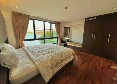 Spacious bedroom with ample natural light and a view