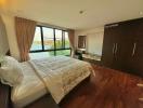 Spacious bedroom with ample natural light and a view